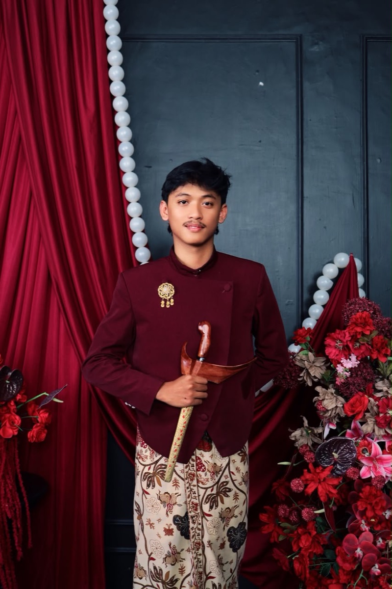 Kivlan mengenakan busana adat Jawa bernuansa burgundy